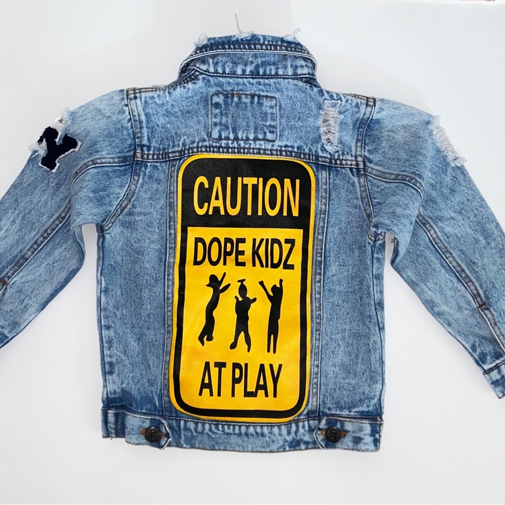 Destroyed Denim blue jean jacket. Copper snap button, 4 pockets, patches,